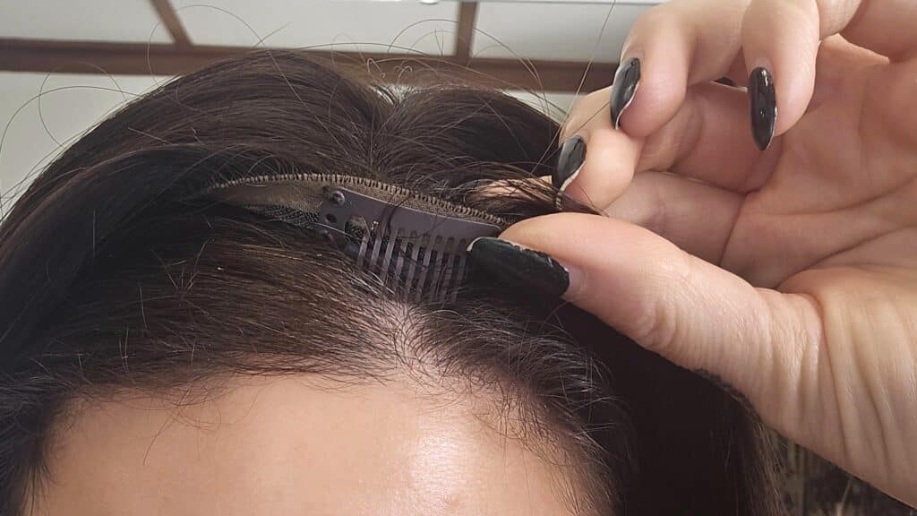 close up of hair topper being applied at Custom Hair Company