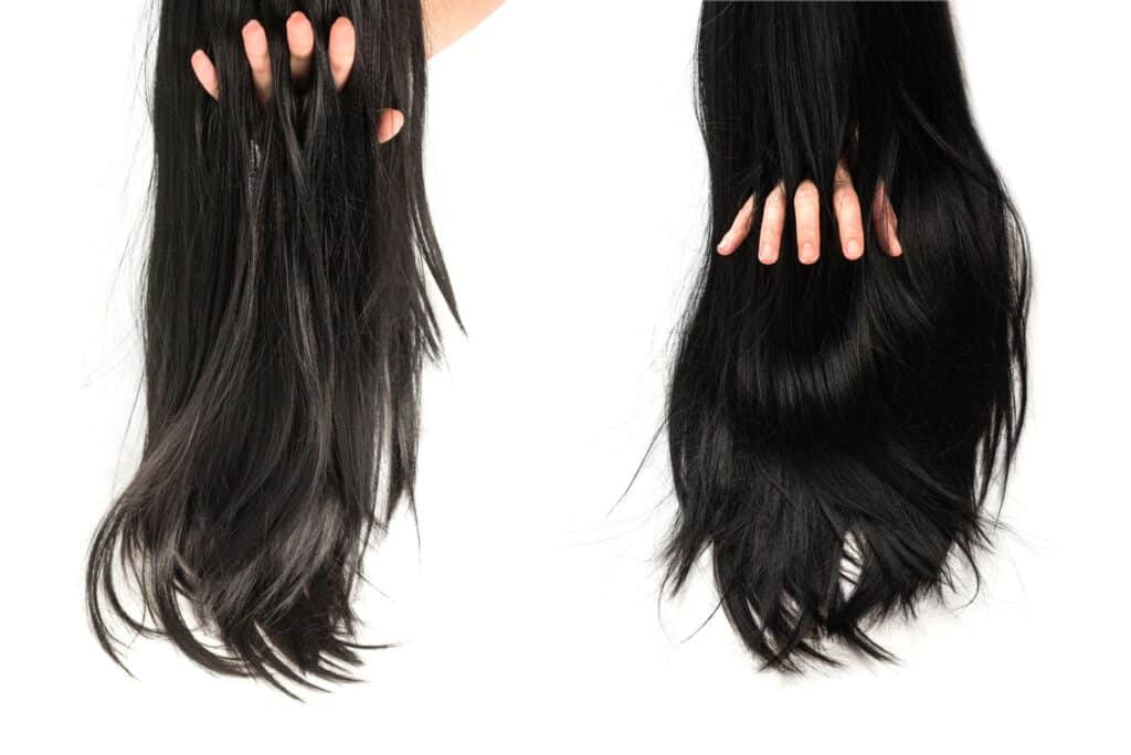 dark hair pieces on white background, person running fingers through to show density
